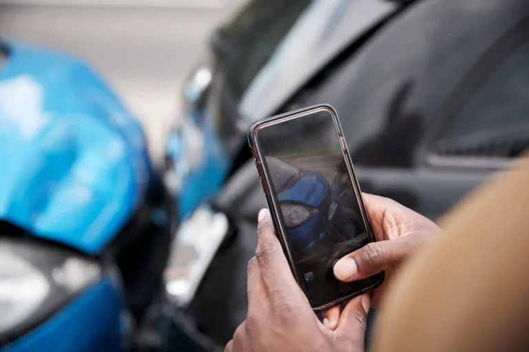 Person taking a photo of a car accident.