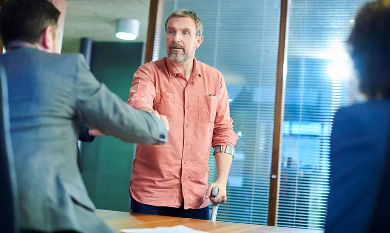 Injured man shaking hands with personal injury attorney