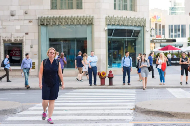 Woman crossing the street in a crosswalk downtown Chicago