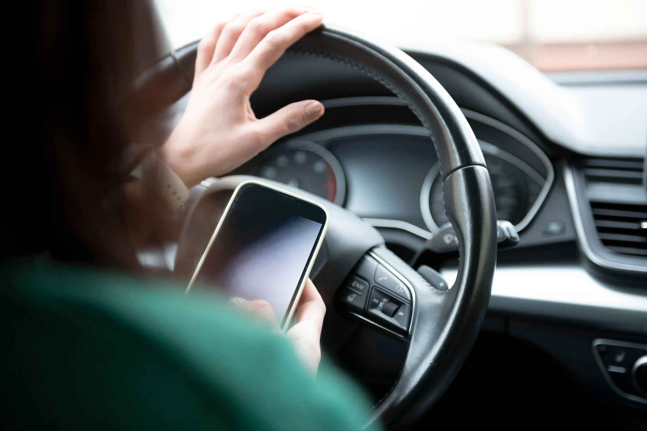 Woman texting while driving the car