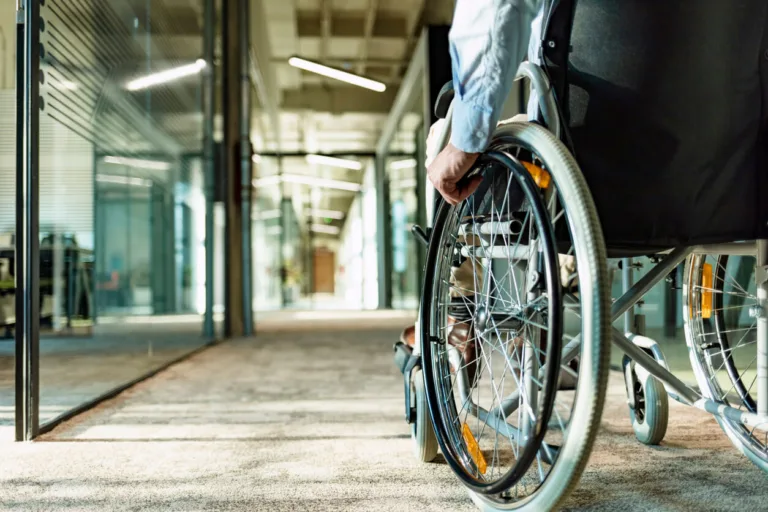 Paralyzed man in a wheelchair on the move in the disabled office building