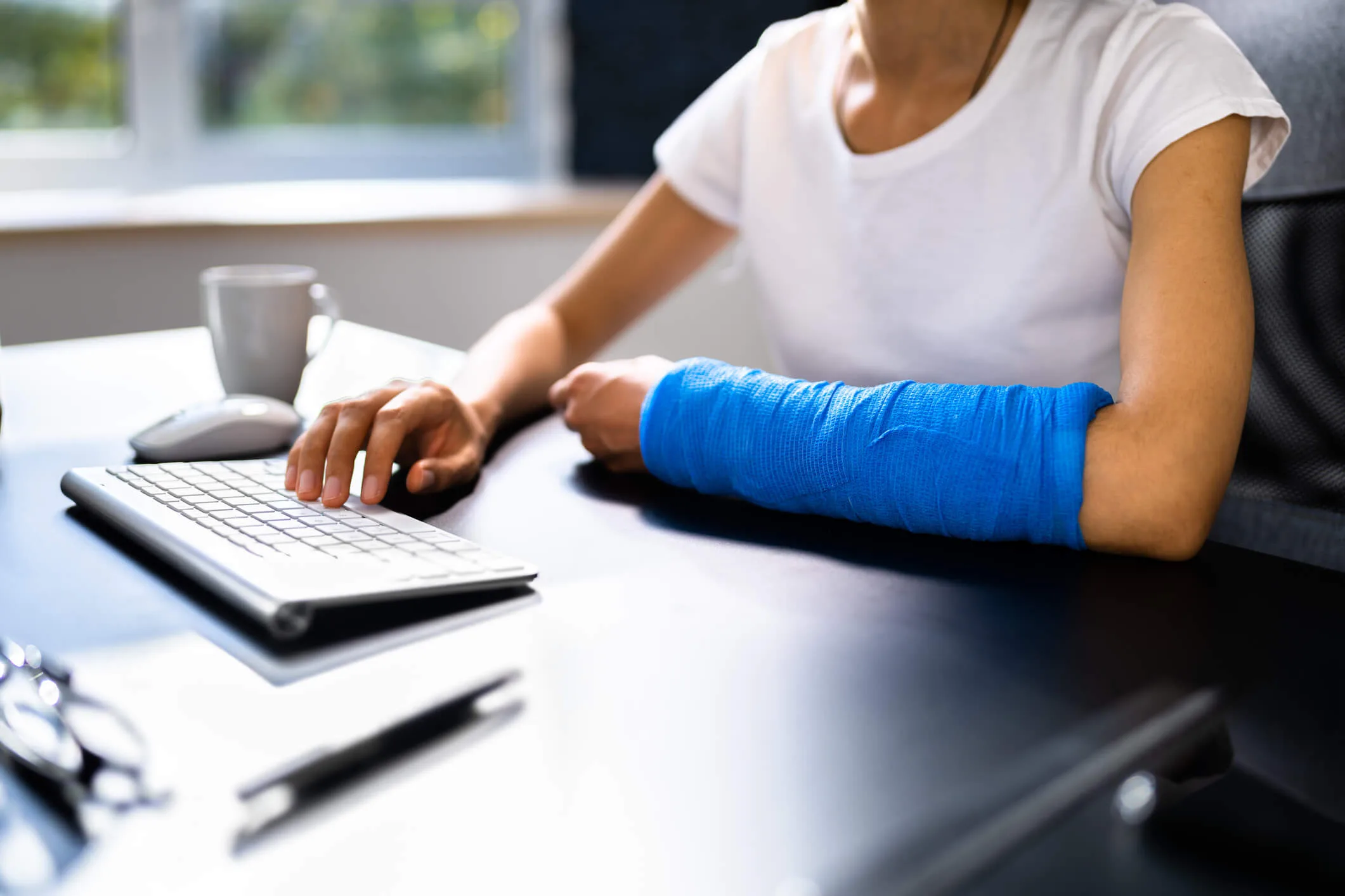 Broken Arm African Woman On Computer