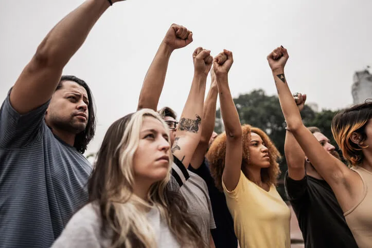 People with fist up during a protest at city street