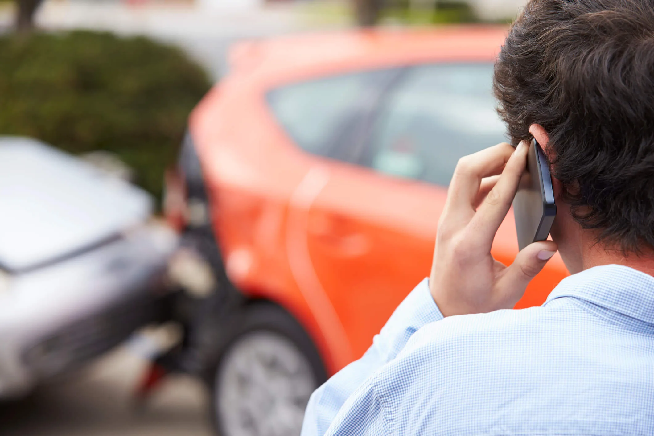 Teenage Driver Making Phone Call After Traffic Accident