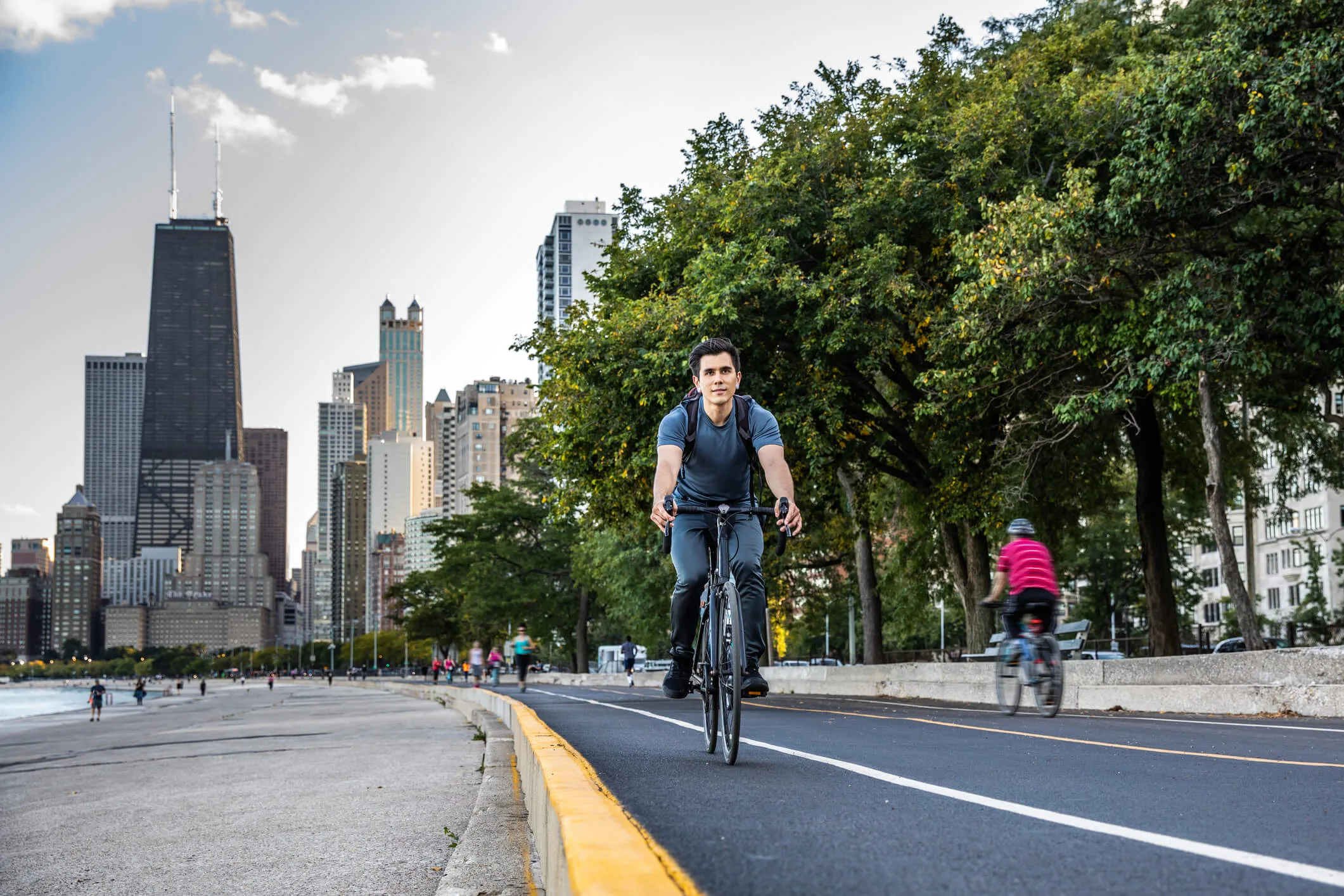 Young man cycling in Chicago by Lake Michigan