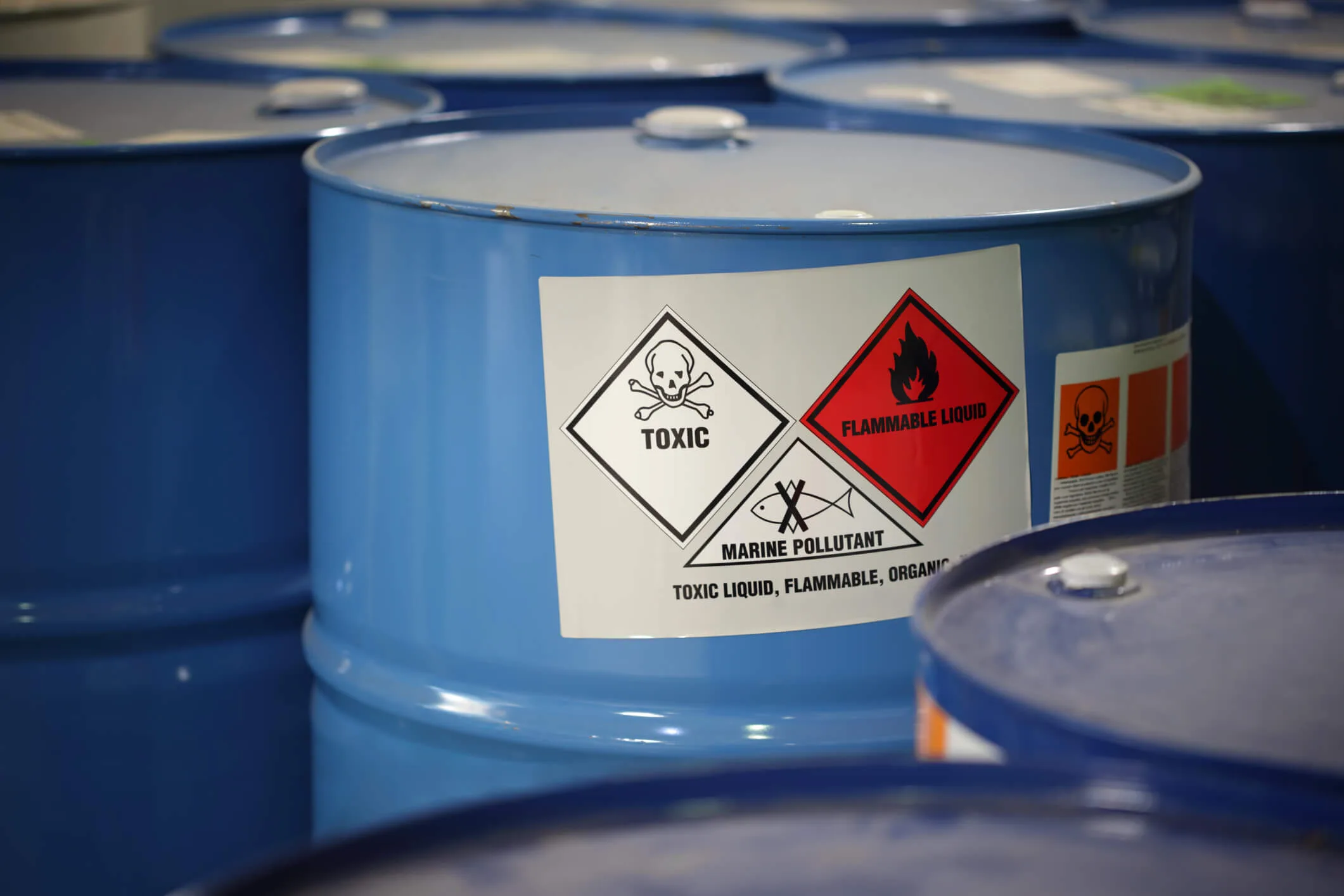 Toxic substances in blue barrels with warning labels