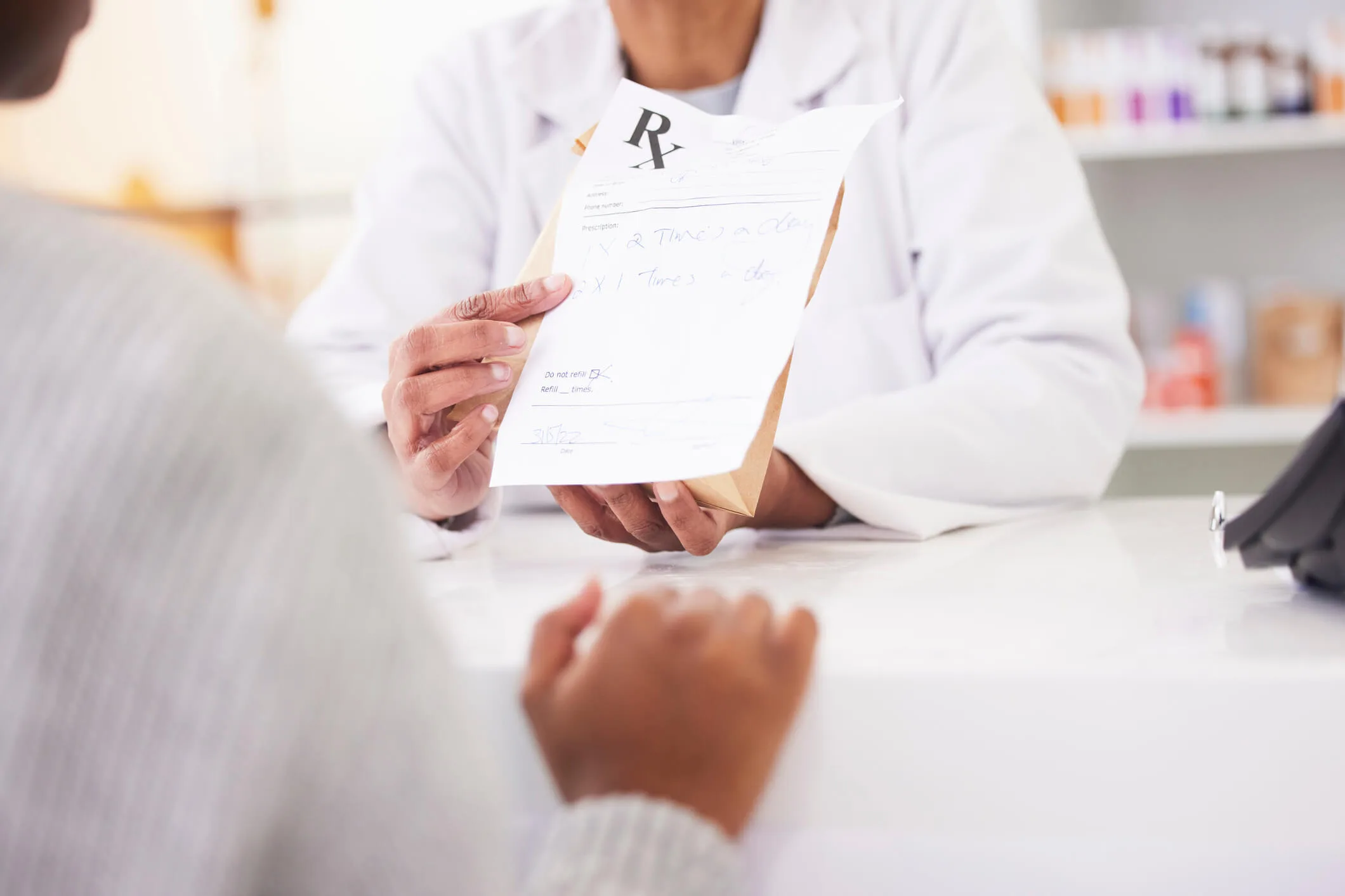 Doctor, hands and patient at pharmacy for medication prescription, drugs or consultation at store. Medical or healthcare professional consulting client on dosage for pharmaceutical product at clinic